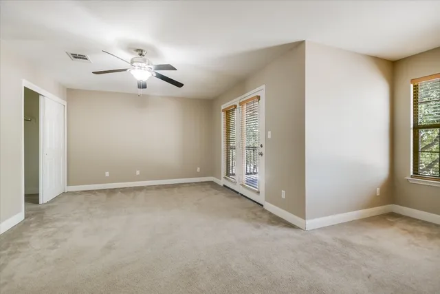 a view of an empty room with a balcony