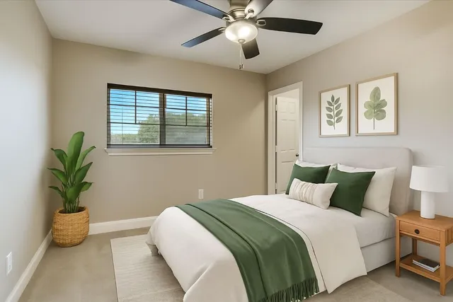 an empty room with a window and a fan