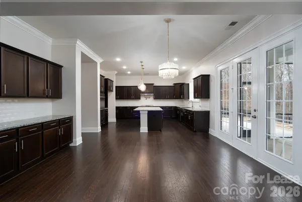 a kitchen with stainless steel appliances kitchen island wooden cabinets and granite counter tops