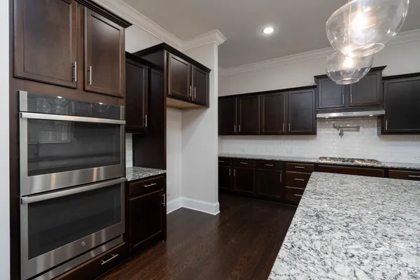 a kitchen with granite countertop stainless steel appliances and wooden cabinets