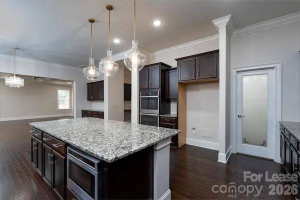 an open kitchen with a table and refrigerator