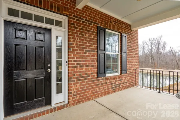 a view of a brick house with a large windows