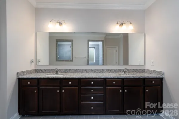 a bathroom with a granite countertop sink a mirror and a vanity