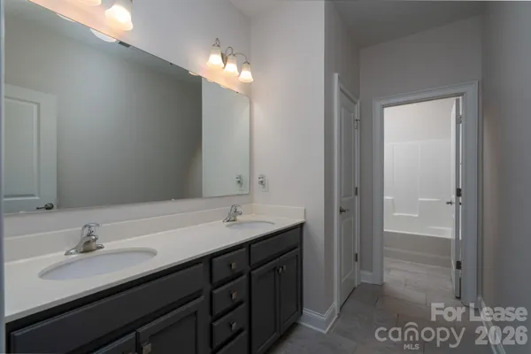 a bathroom with a sink double vanity and a mirror