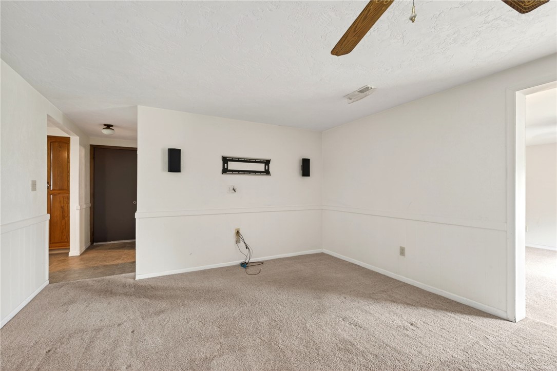 7988 McCool Road Greenville, OH 45331 - Photo 11 of 50 This living area features comfortable carpeting and a connection to the adjoining room.