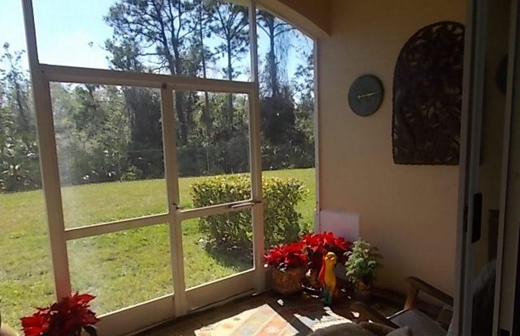 370 Southwest Walking Path, Unit 370 Stuart, FL 34997 - Photo 19 of 38 Screened porch with a preserve view