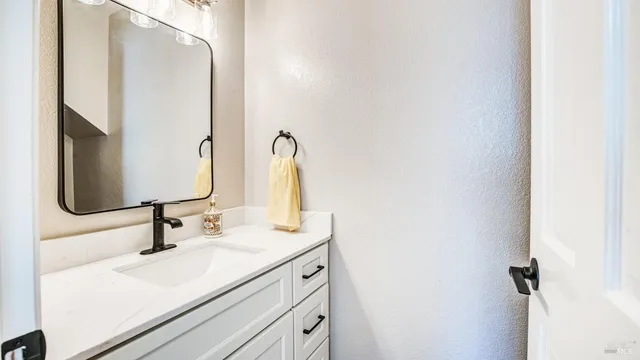 a bathroom with a double vanity sink mirror and shower