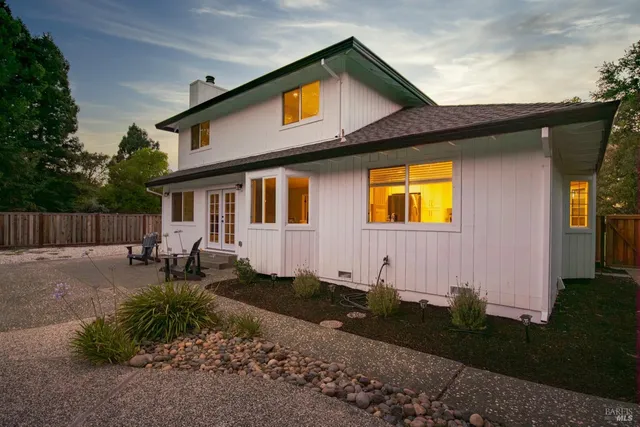 an aerial view of a house with a yard swimming pool and outdoor seating