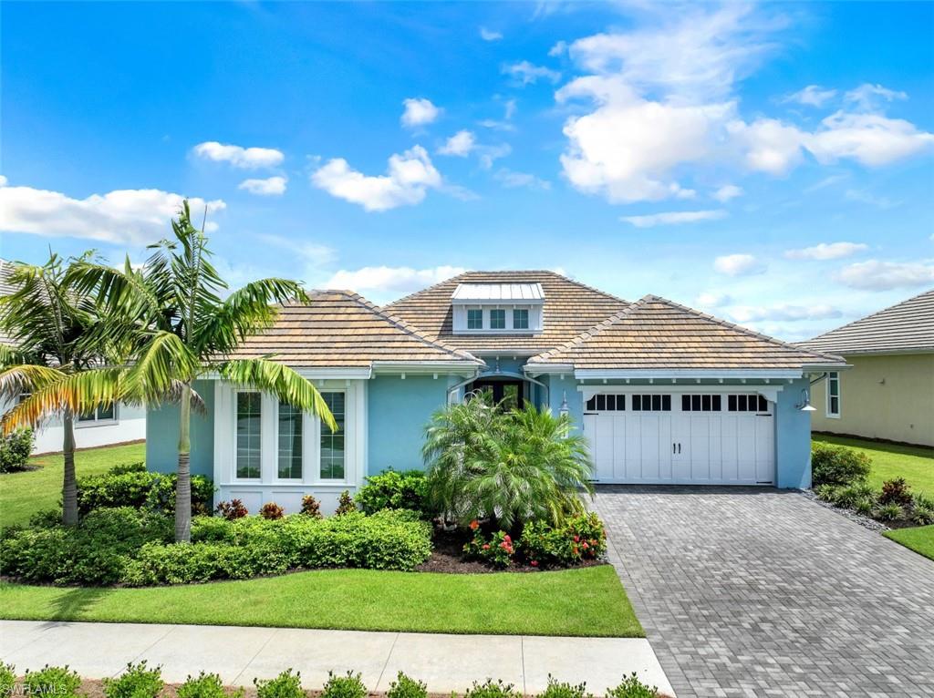 5771 Clarendon Drive Naples, FL 34113 - Photo 1 of 33 front view of a house with a yard