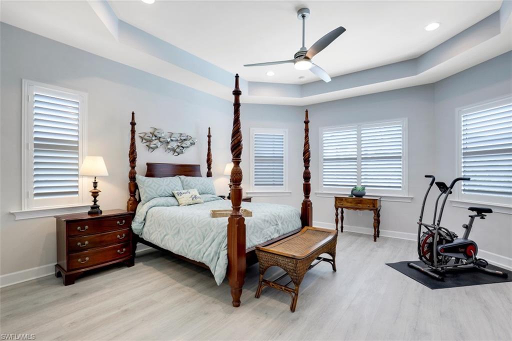 5771 Clarendon Drive Naples, FL 34113 - Photo 13 of 33 a bedroom with furniture and a bed