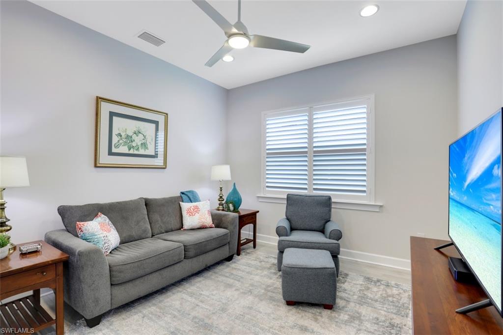 5771 Clarendon Drive Naples, FL 34113 - Photo 18 of 33 a living room with furniture and a flat screen tv
