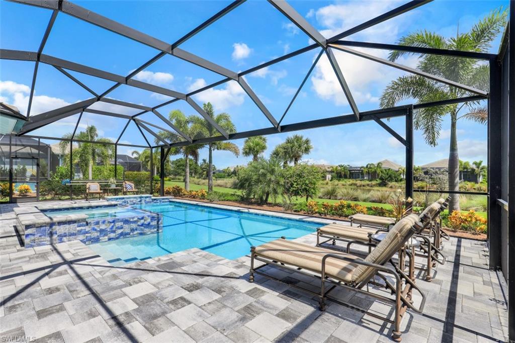 5771 Clarendon Drive Naples, FL 34113 - Photo 26 of 33 a view of a swimming pool with a patio