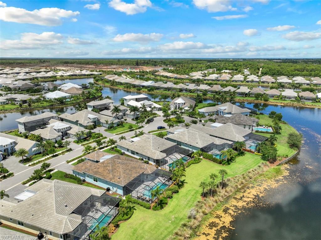 5771 Clarendon Drive Naples, FL 34113 - Photo 28 of 33 an aerial view of residential building and lake