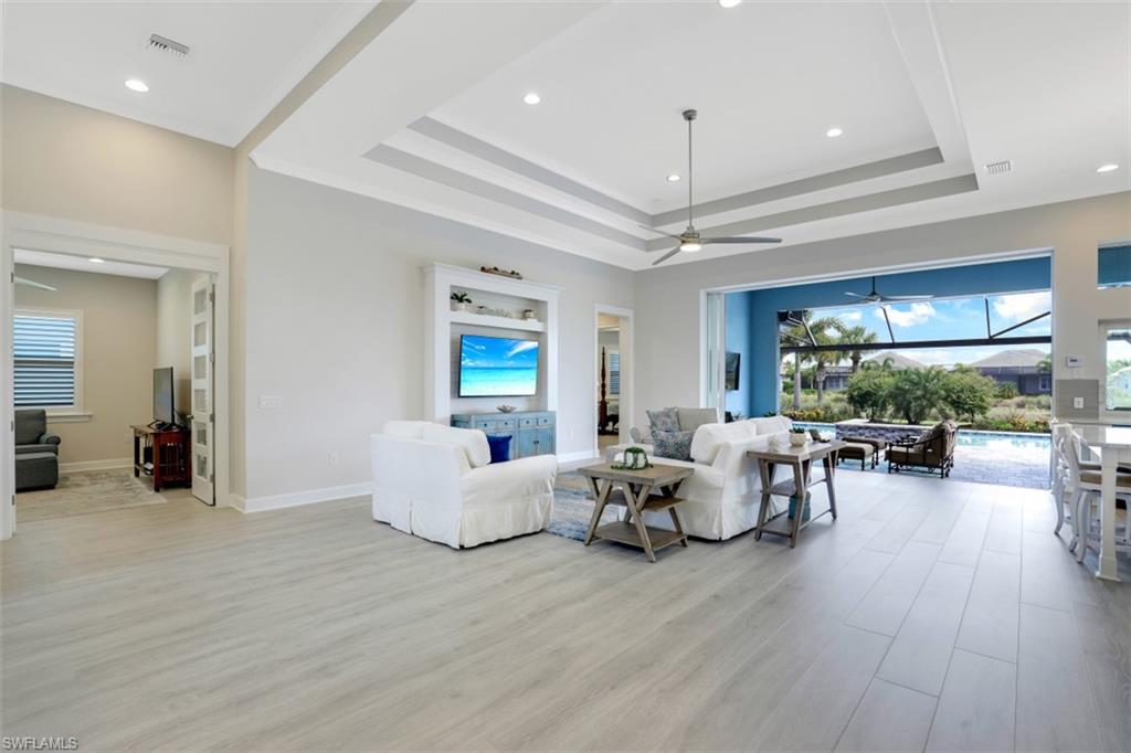 5771 Clarendon Drive Naples, FL 34113 - Photo 3 of 33 a living room with furniture and a large window