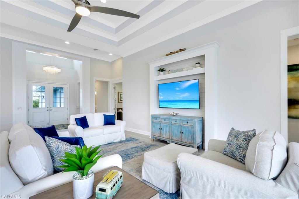 5771 Clarendon Drive Naples, FL 34113 - Photo 4 of 33 a bedroom with a bed couches and painted walls