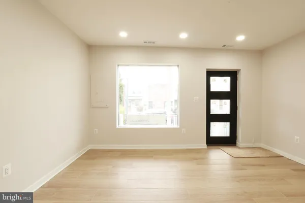 an empty room with windows and closet