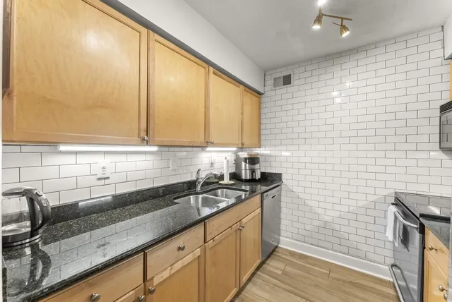 a kitchen with a sink and cabinets