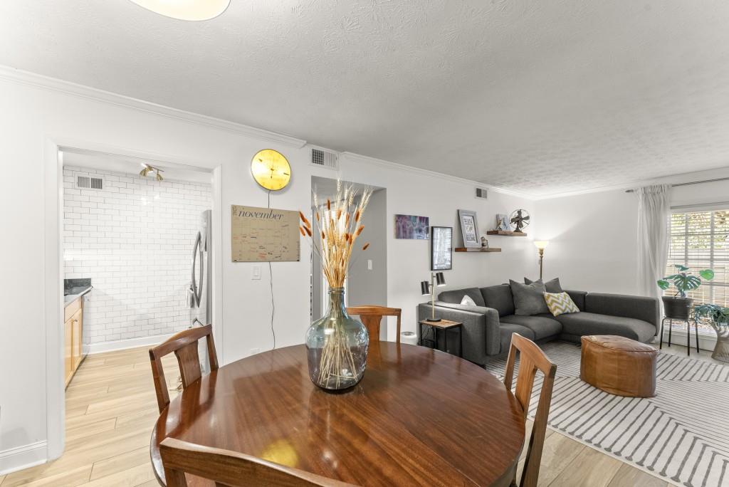 1150 Collier Road Northwest, Unit J18 Atlanta, GA 30318 - Photo 16 of 32 a living room with furniture and wooden floor