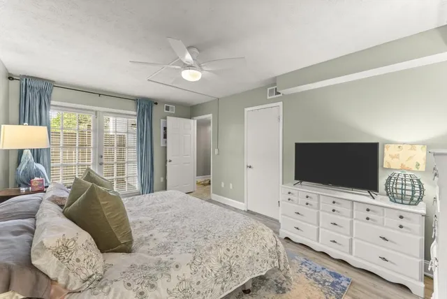 a bedroom with a large bed and a flat screen tv