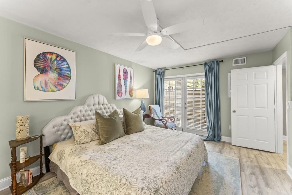 1150 Collier Road Northwest, Unit J18 Atlanta, GA 30318 - Photo 18 of 32 a large bed sitting in a bedroom next to a window