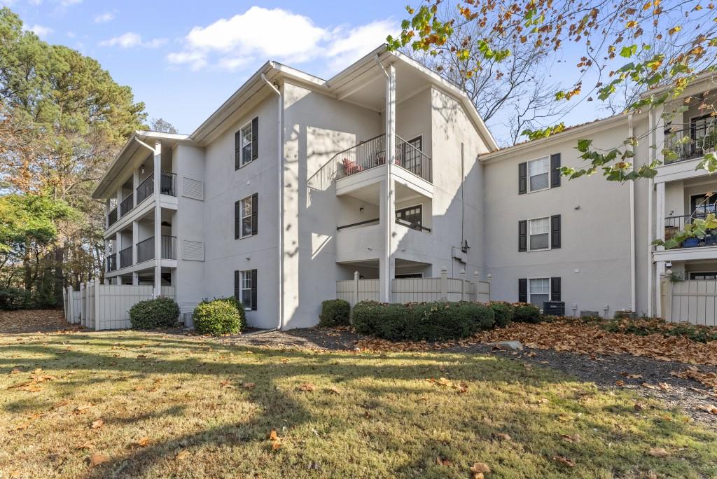 1150 Collier Road Northwest, Unit J18 Atlanta, GA 30318 - Photo 25 of 32 a front view of a house with a yard