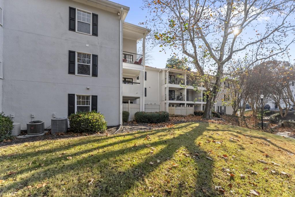 1150 Collier Road Northwest, Unit J18 Atlanta, GA 30318 - Photo 26 of 32 a view of a house with a yard