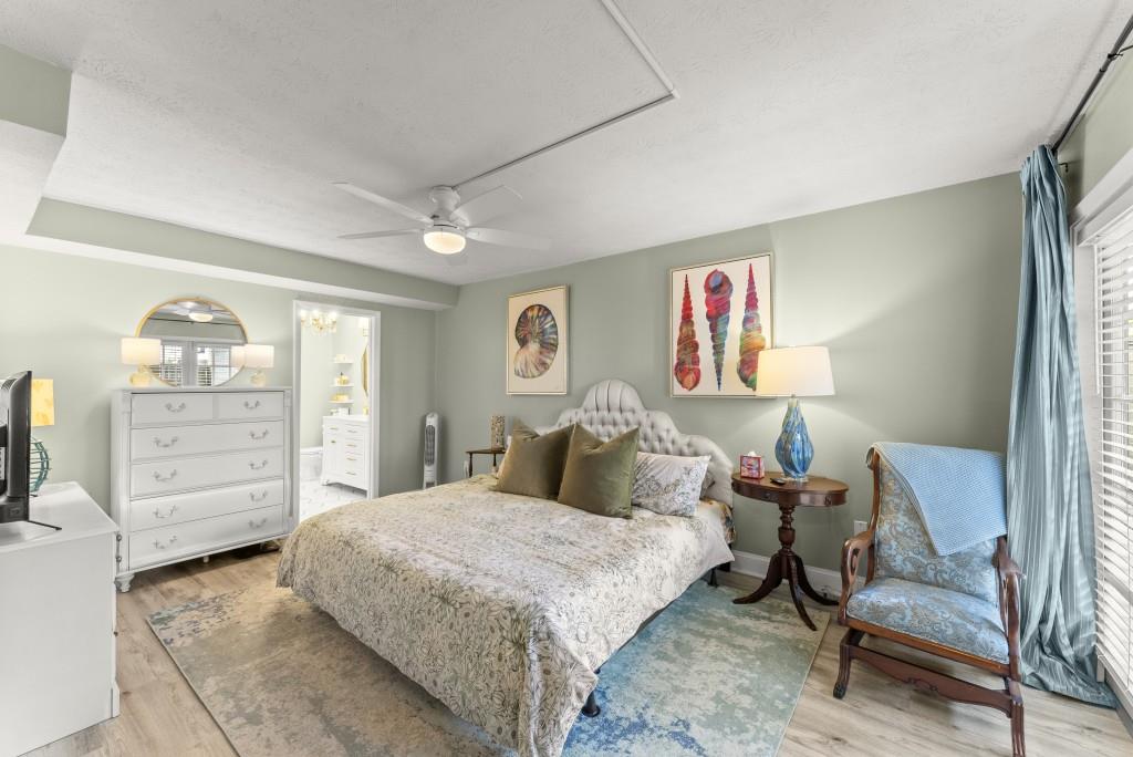 1150 Collier Road Northwest, Unit J18 Atlanta, GA 30318 - Photo 4 of 32 a bed room with a bed and a chair