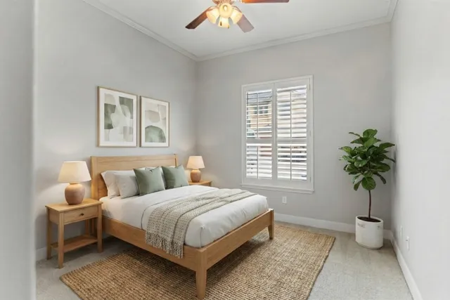 a bedroom with a large bed and a potted plant