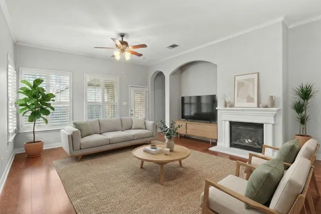 a living room with furniture a fireplace and a potted plant