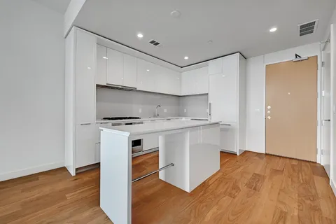 a kitchen with granite countertop a stove and a refrigerator