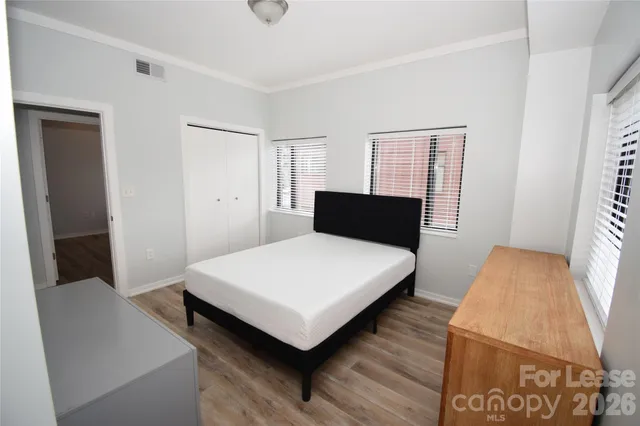 a bathroom with a granite countertop sink toilet and a mirror