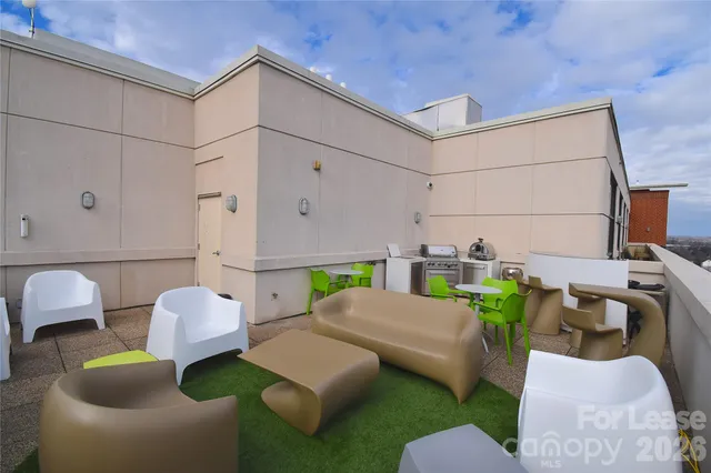 a view of a swimming pool with lounge chairs in patio