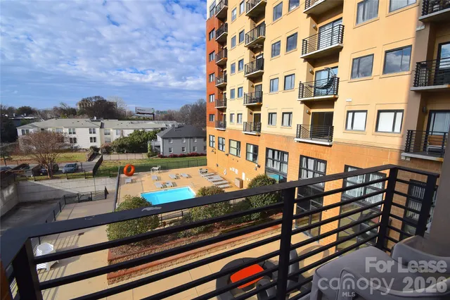a kitchen with granite countertop a refrigerator and a stove top oven