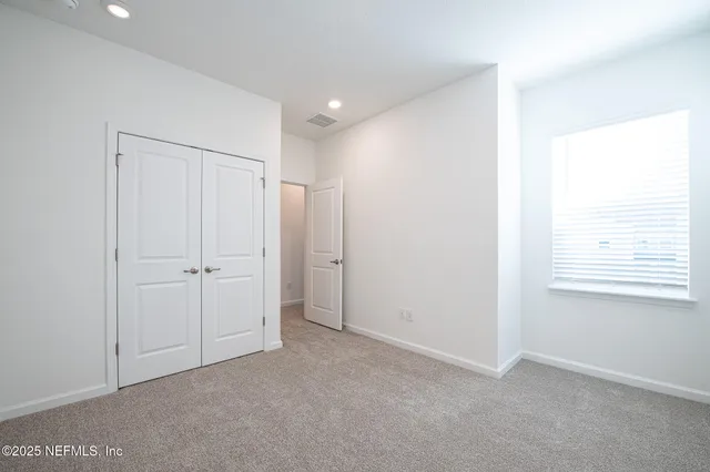 a view of an empty room and a window
