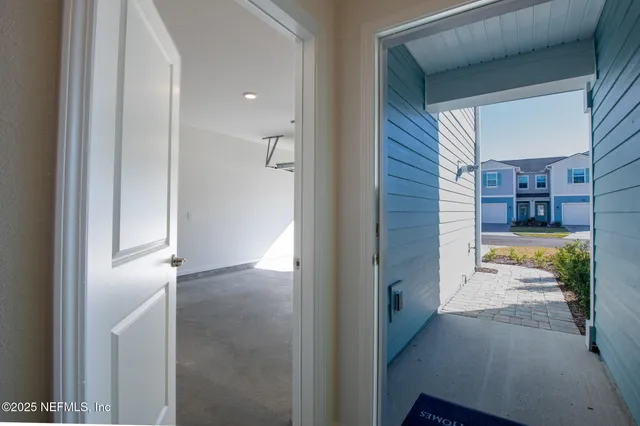 a view of a bathroom from a corridor