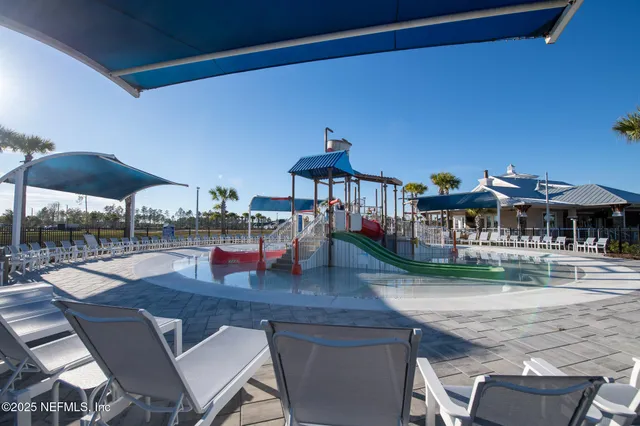 a balcony with table and chairs