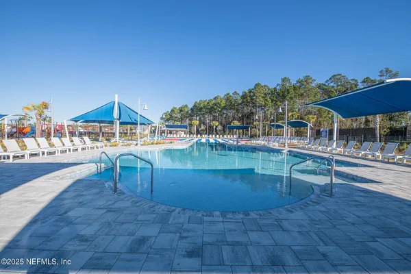 a view of a swimming pool with a patio