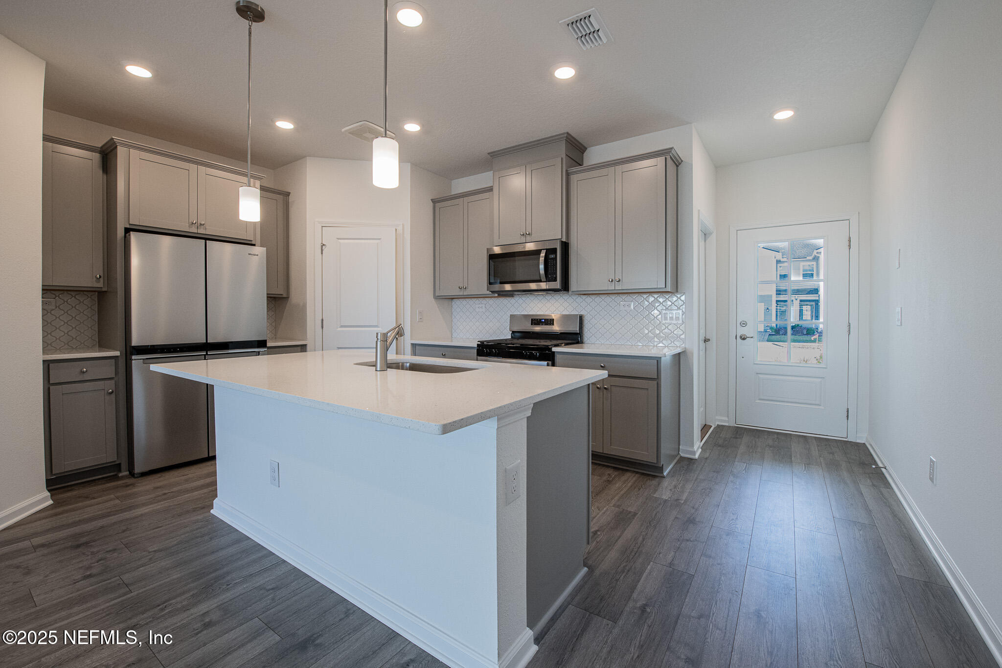 259 Brandon Lks Drive St. Augustine, FL 32092 - Photo 4 of 29 a kitchen with kitchen island a sink a counter top space stainless steel appliances and cabinets
