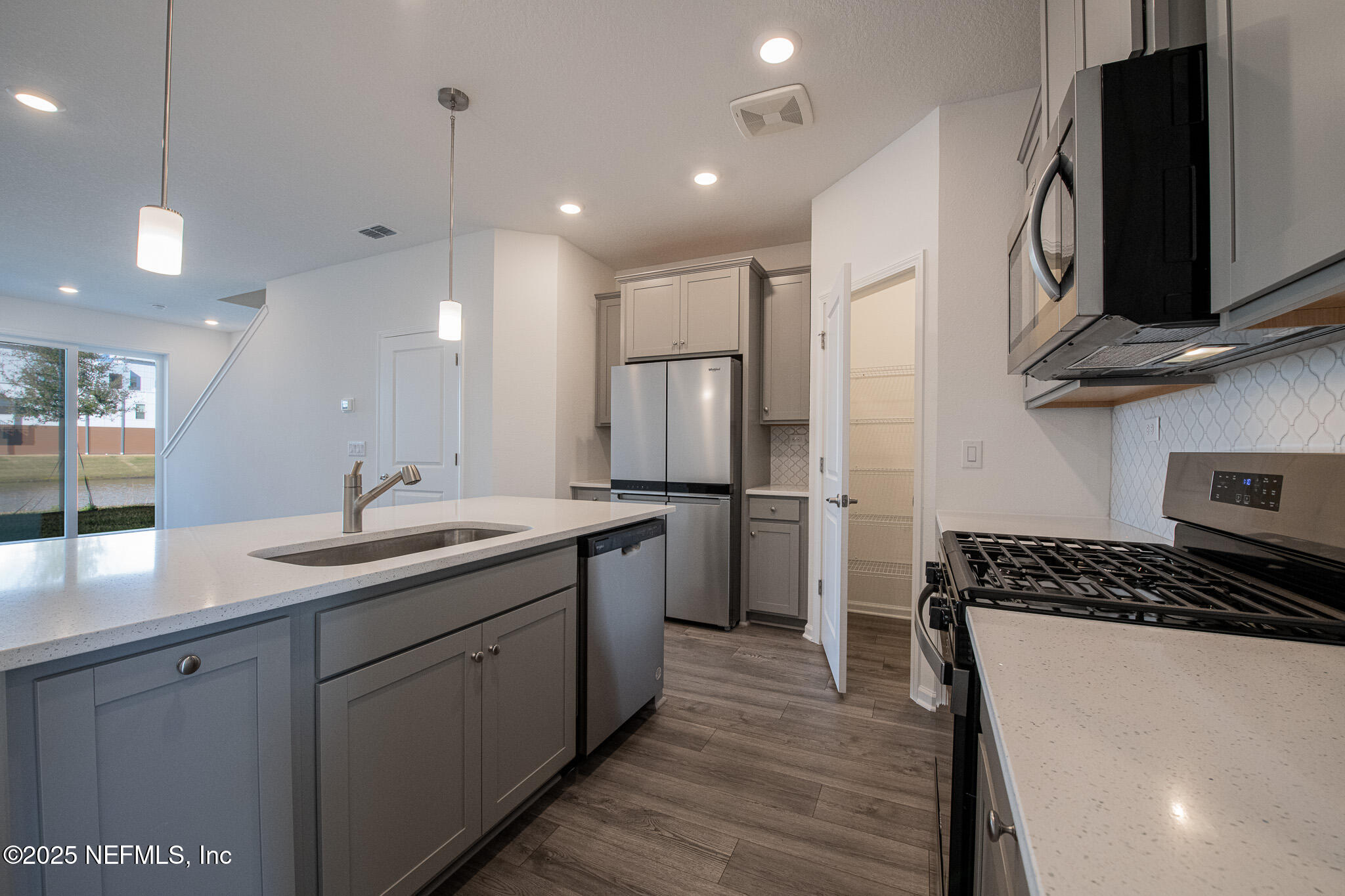 259 Brandon Lks Drive St. Augustine, FL 32092 - Photo 5 of 29 a kitchen with a sink stove and cabinets
