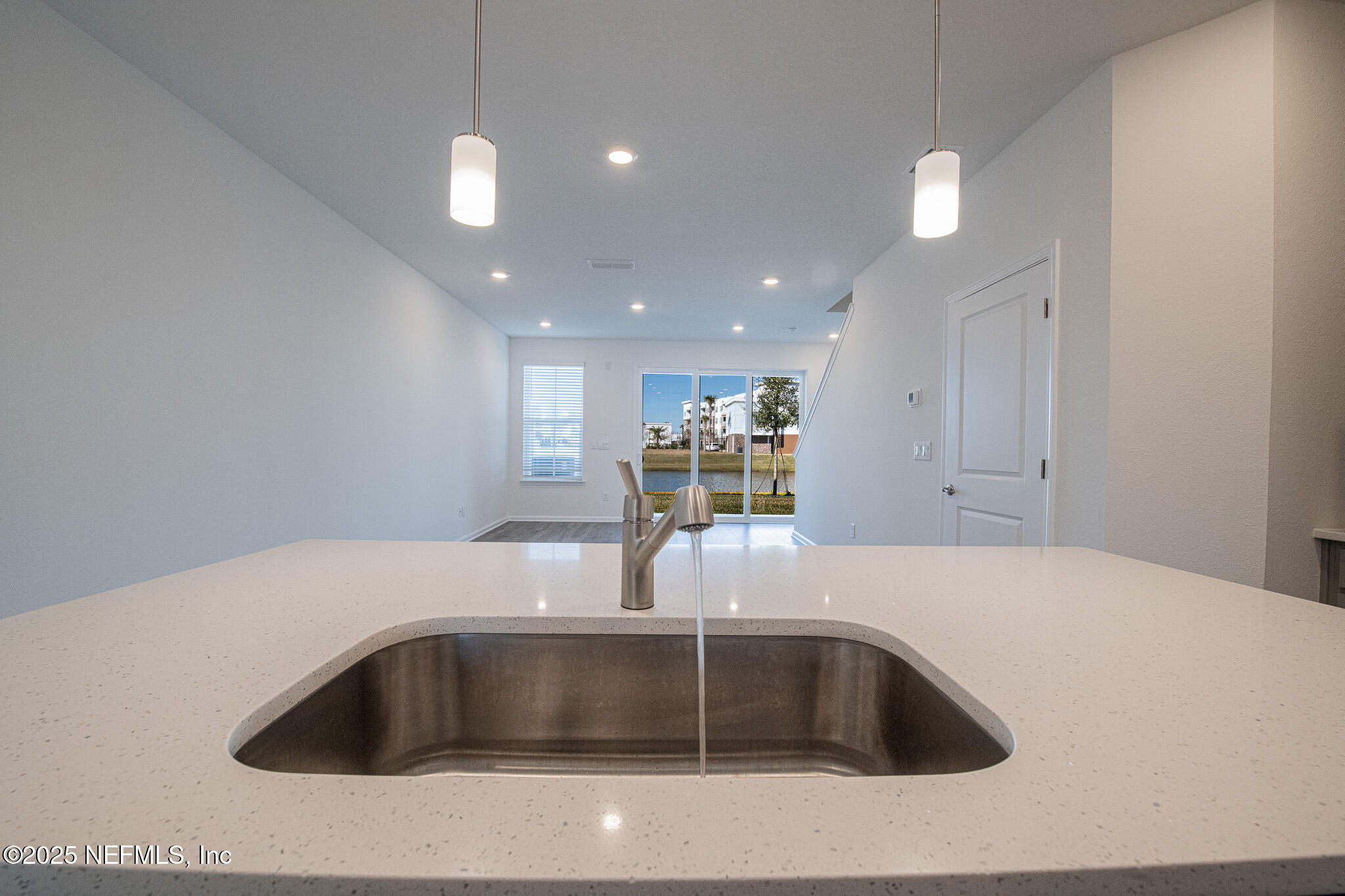 259 Brandon Lks Drive St. Augustine, FL 32092 - Photo 6 of 29 a kitchen with kitchen island a sink and a refrigerator