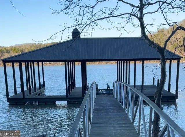a view of a roof deck with wooden floor and fence