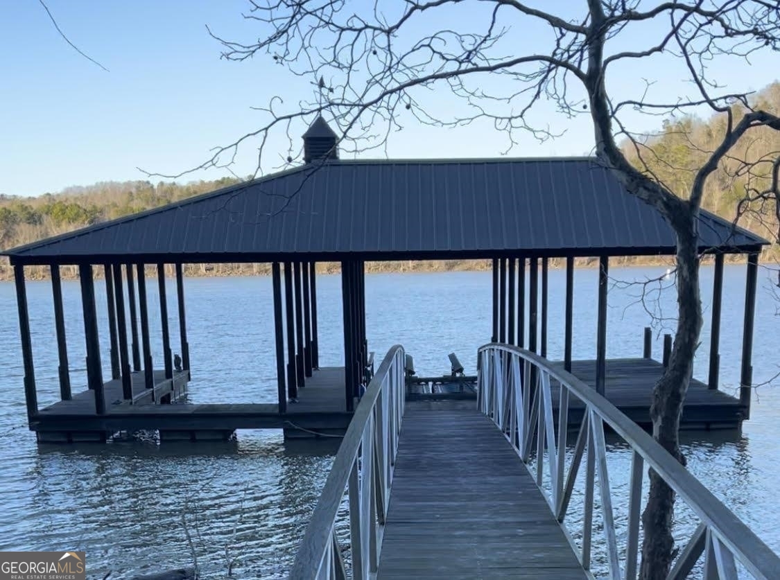 1212 Edgewater Trail Toccoa, GA 30577 - Photo 4 of 5 a view of a roof deck with wooden floor and fence