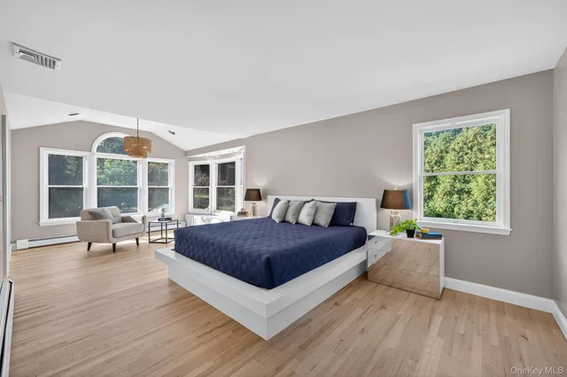 a living room with a bed furniture and a large window