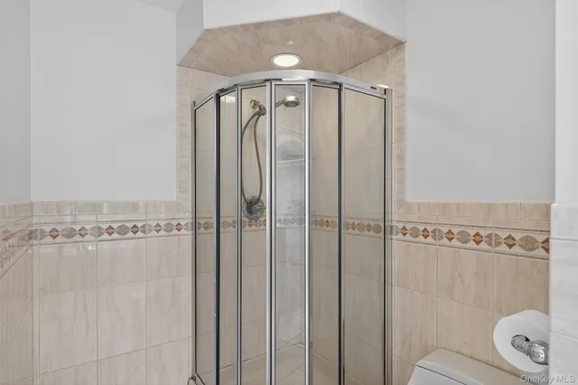 a bathroom with a shower a toilet and a sink