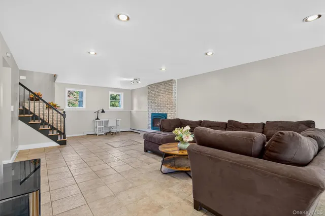 a living room with furniture and stairs