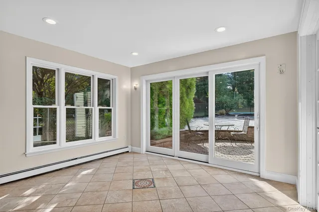 a view of an empty room with a floor to ceiling window and an outdoor view