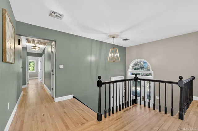 a view of a hallway with a hardwood floor