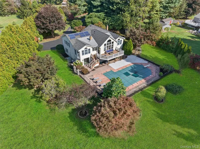 an aerial view of a house with garden space and street view