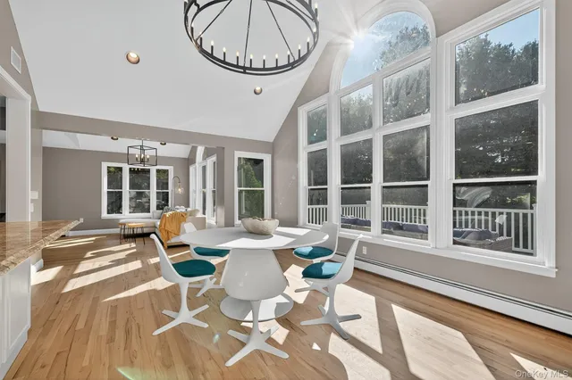 a view of a dining room with furniture window and wooden floor