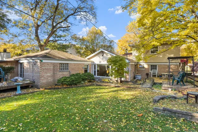 a front view of a house with garden and sitting area